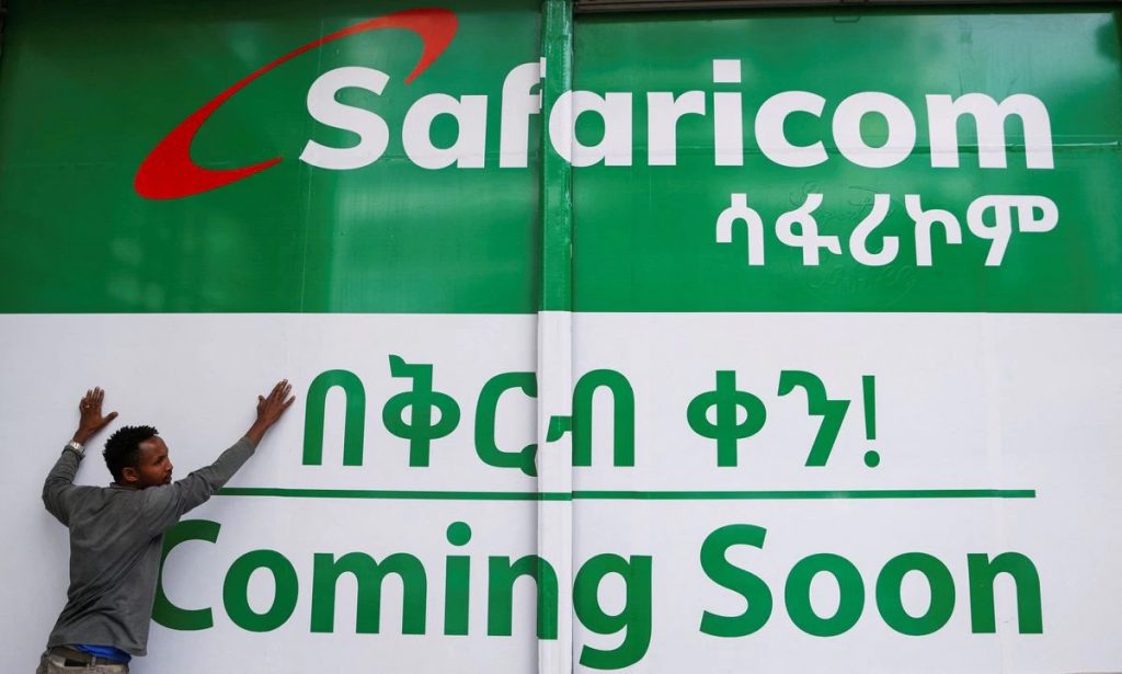[2/2] An employee fixes a branding sticker on the Safaricom Ethiopia retail shop in Addis Ababa, Ethiopia, July 29, 2022. REUTERS/Tiksa Negeri
